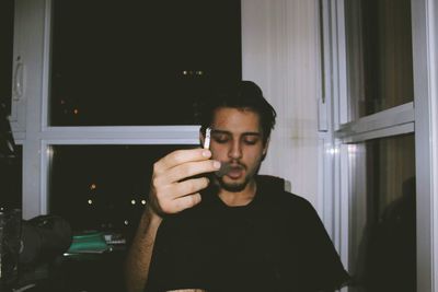Portrait of young man using smart phone