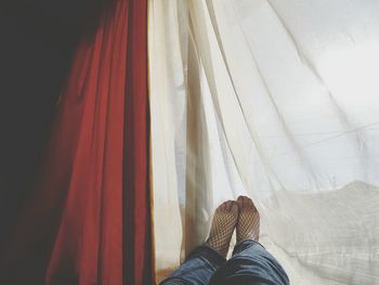 Low section of woman lying on bed