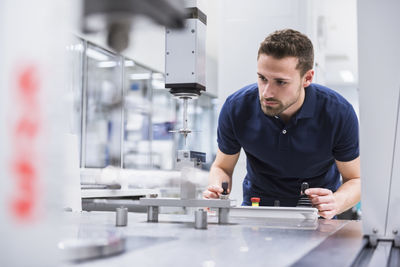 Man operating machine in testing instrument room