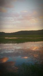 Scenic view of lake at sunset