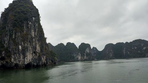 Scenic view of sea and mountains against sky