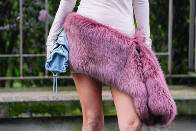 Low section of woman standing on footpath