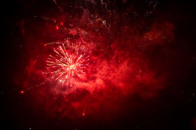 Low angle view of firework display at night