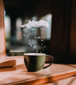 Close-up of coffee cup on table