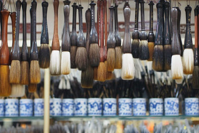 Brushes hanging in market for sale