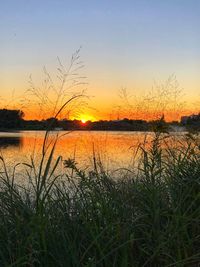 Scenic view of lake against romantic sky at sunset