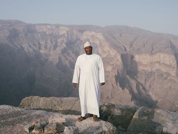 Portrait of man standing on rock