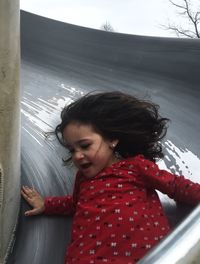 Close-up of woman sitting on wall