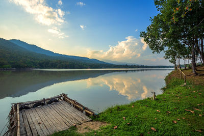 Scenic view of lake and trees against sky