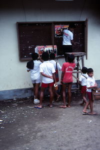 Rear view of people standing outdoors