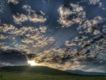 Scenic view of landscape against cloudy sky