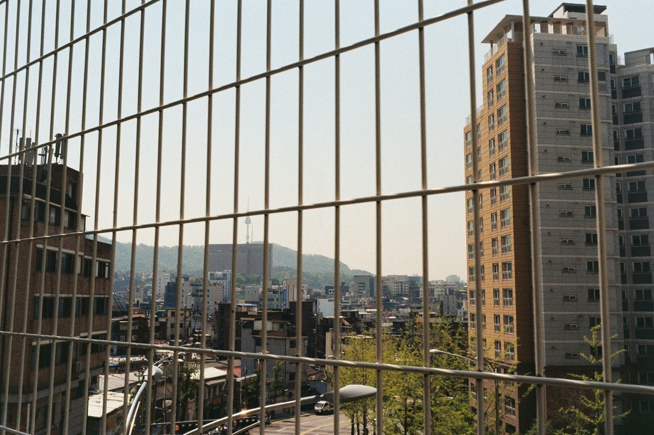 MODERN BUILDINGS IN CITY SEEN THROUGH WINDOW