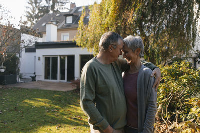 Affectionate senior couple embracing in garden