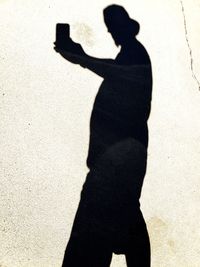 Shadow of man on street