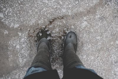 Low section of man standing on ground