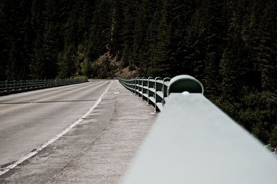 Empty bridge against trees