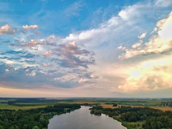 Scenic view of river against sky during sunset