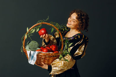 Portrait of young woman holding christmas tree