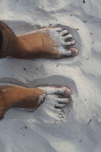 Low section of person on sand