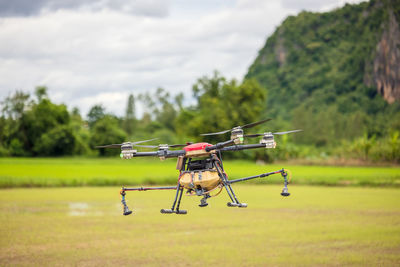 Agriculture drones fly over rice fields sprinkling fertilizer, 