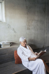 Senior woman reading magazine