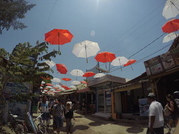 People on street in city against sky