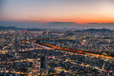 High angle view of illuminated cityscape sky during sunset