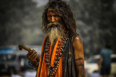 Portrait of sadhu standing outdoors