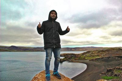 Full length portrait of man standing on shore