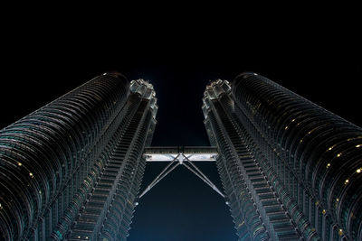 Low angle view of modern building against sky at night