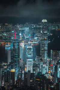 Illuminated cityscape against sky at night