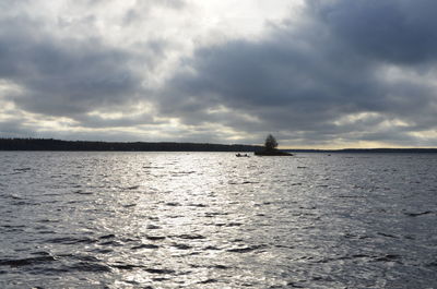 View of calm sea against cloudy sky