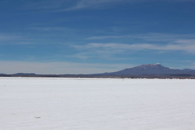 Scenic view of desert against blue sky