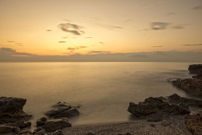 Scenic view of sea against sky at sunset