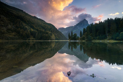 Scenic view of lake and mountains against sky