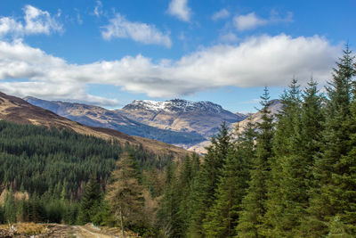 Scenic view of mountains against cloudy sky