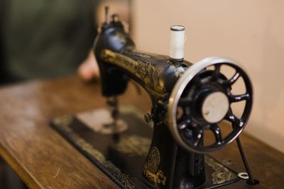 Close-up of old machine part on table