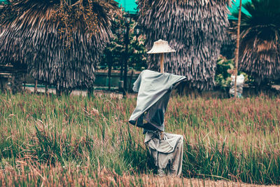 Rear view of woman walking on field