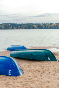 Boat moored on beach against sky