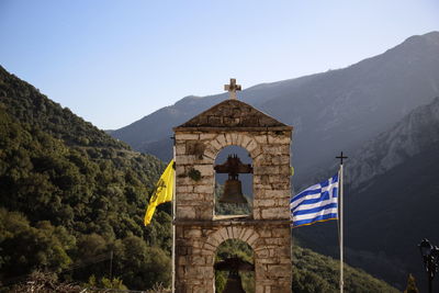 View of bell tower and mountain against sky