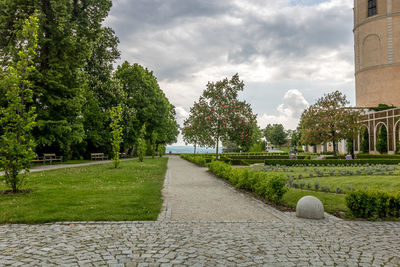 Footpath in park against sky