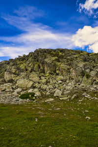 Rock formations on landscape against sky