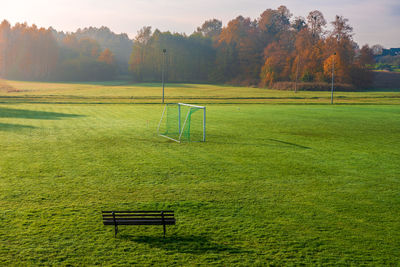 Small, local football pitch.football gates placed on the grass. beautiful, foggy, autumn morning