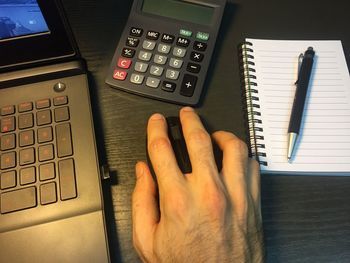 High angle view of human hand on table