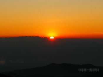 Scenic view of silhouette landscape against romantic sky at sunset