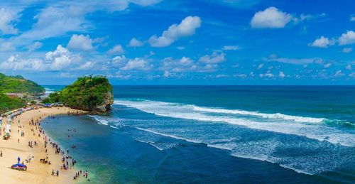 Scenic view of beach against blue sky