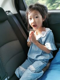 Cute girl sitting in car