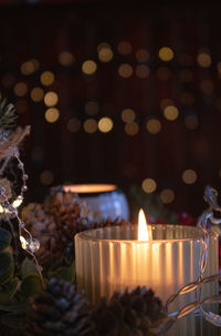 Close-up of illuminated candles on table