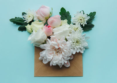 Envelope with pink flowers on blue background.