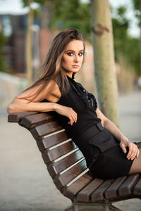 Portrait of young woman sitting outdoors